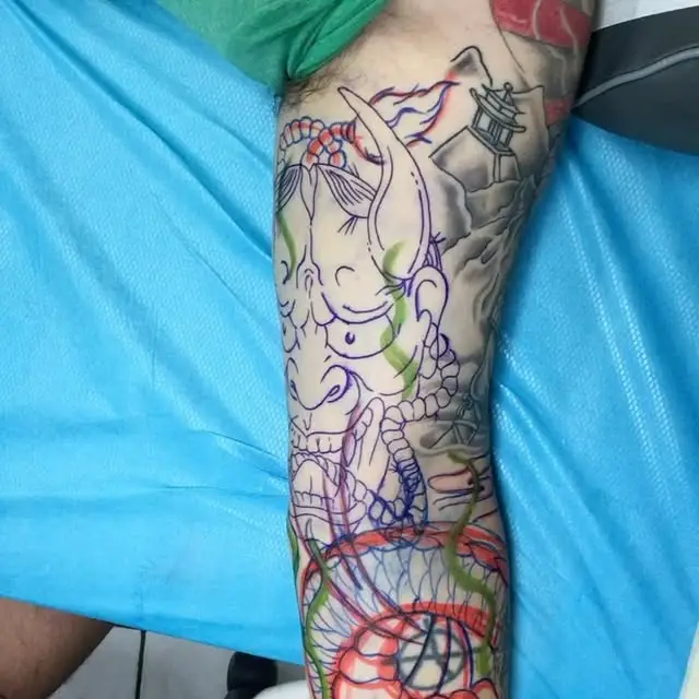 A Japanese style hannya mask sleeve at the linework stage, with a pagoda and clouds already outlined